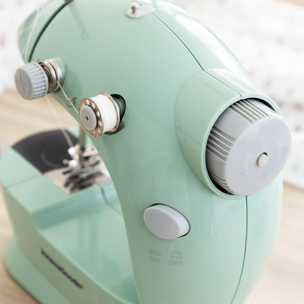 detalle de la Mini máquina de coser portátil con accesorios y luz LED. rueda de hilo 
